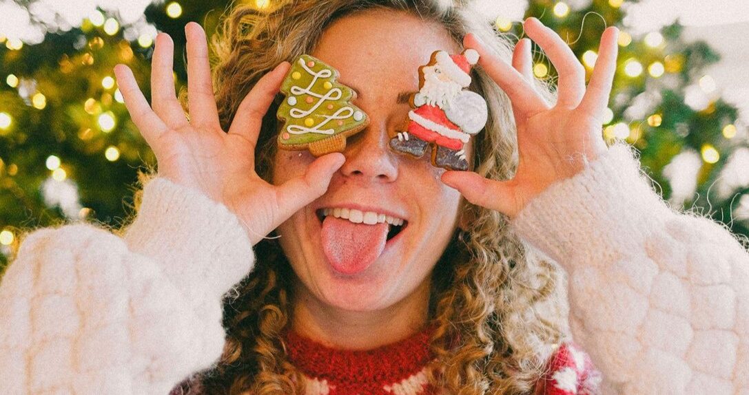 Beautiful girl with two Christmas cookies